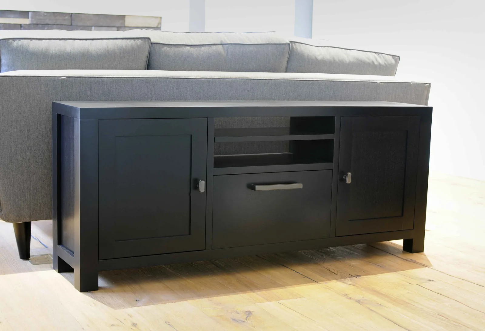 Birch media console with a dark finish, two cabinet doors and a centre drawer