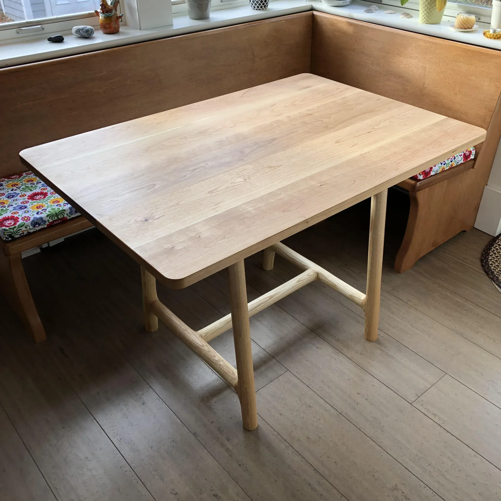 Cherry table set against a built-in bench seat