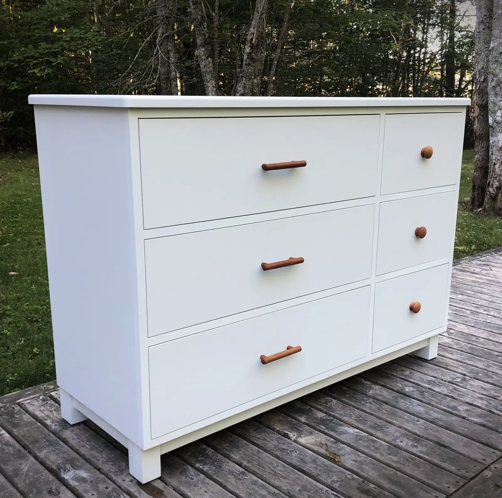 White maple dresser with six drawers on a deck